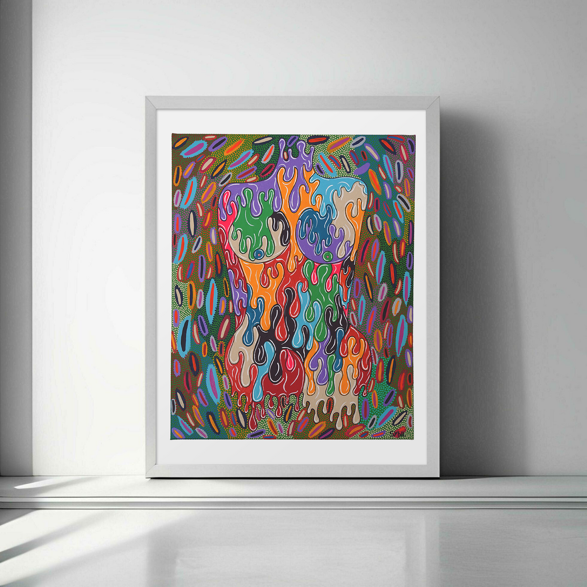 Framed abstract artwork with colorful patterns on a white wall.